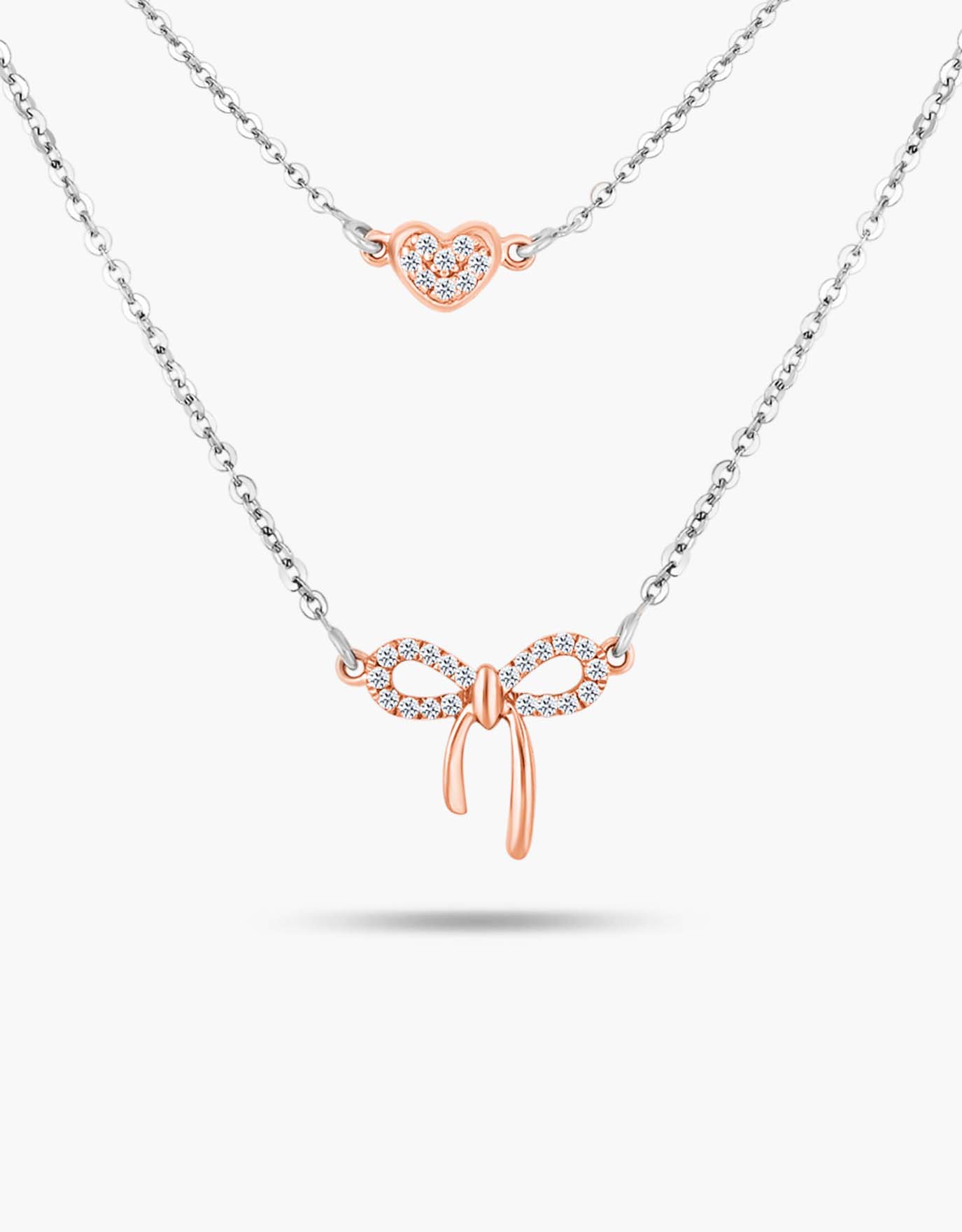 LVC necklace designed with a dainty bow layered with a heart pendant in rose gold encrusted with diamonds 