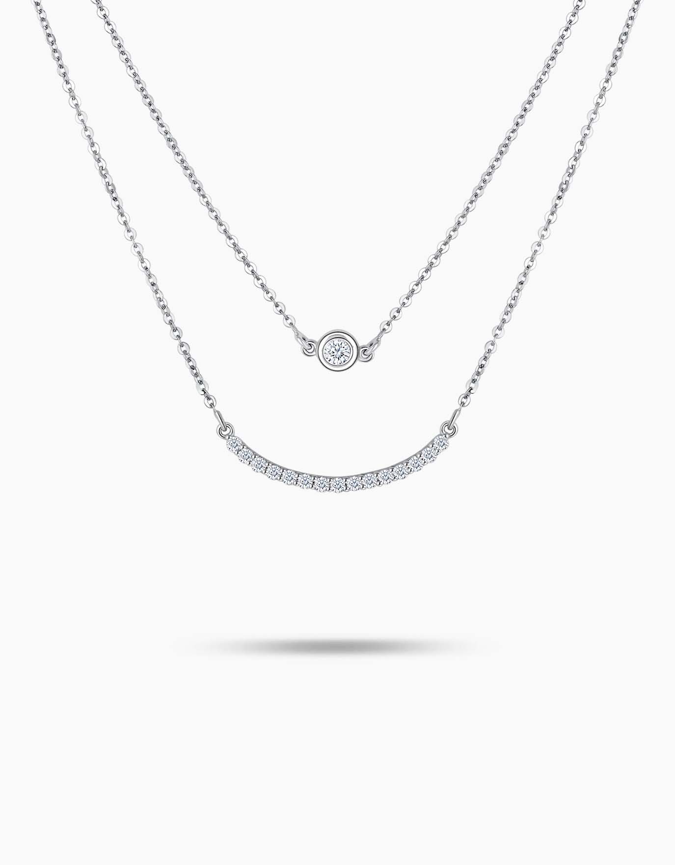 LVC necklace in white gold  features a delicate curve of pave round diamonds and a circlet pendant