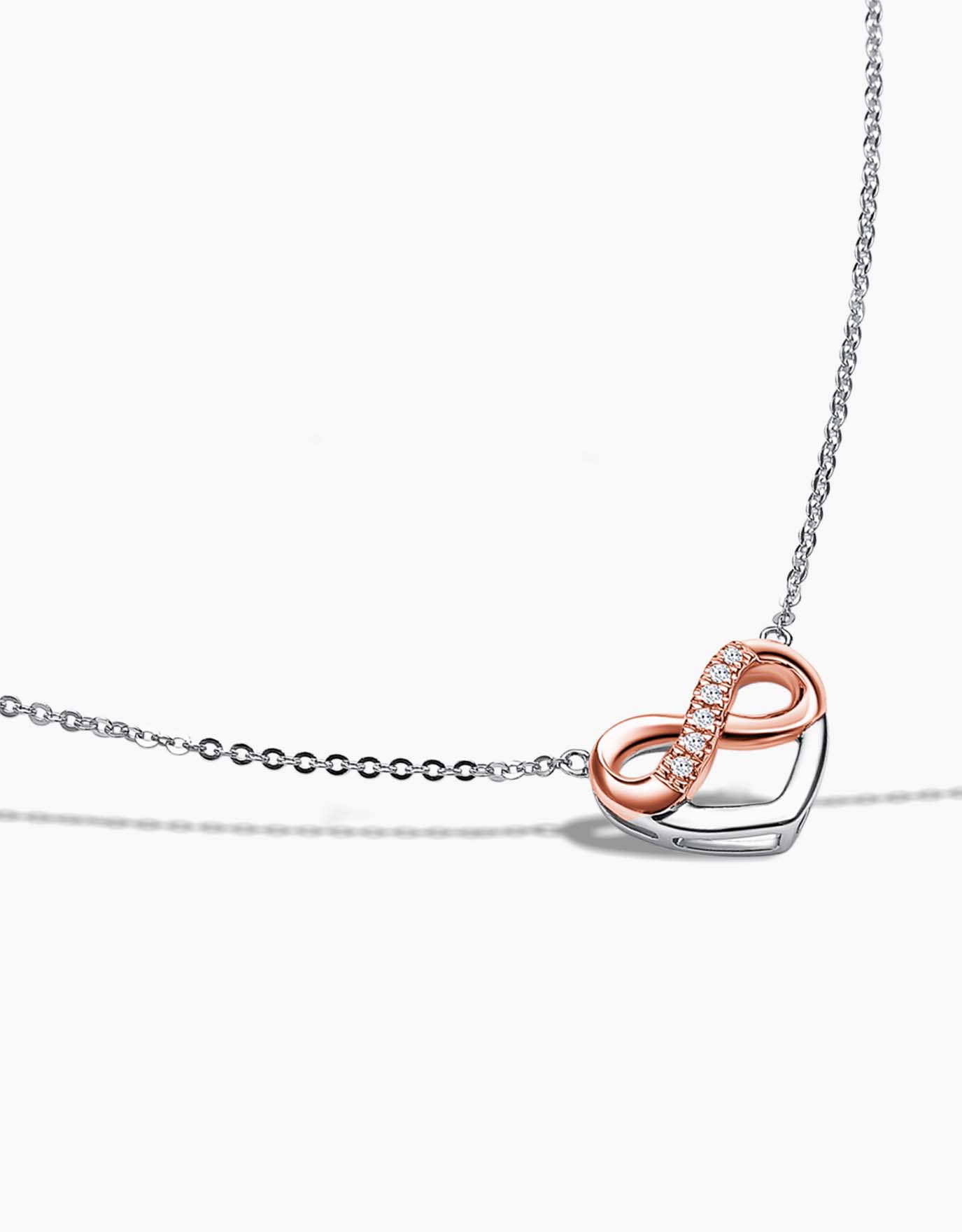 LVC necklace in white gold designed with an infinity symbol in rose gold encrusted with diamonds resting within a heart