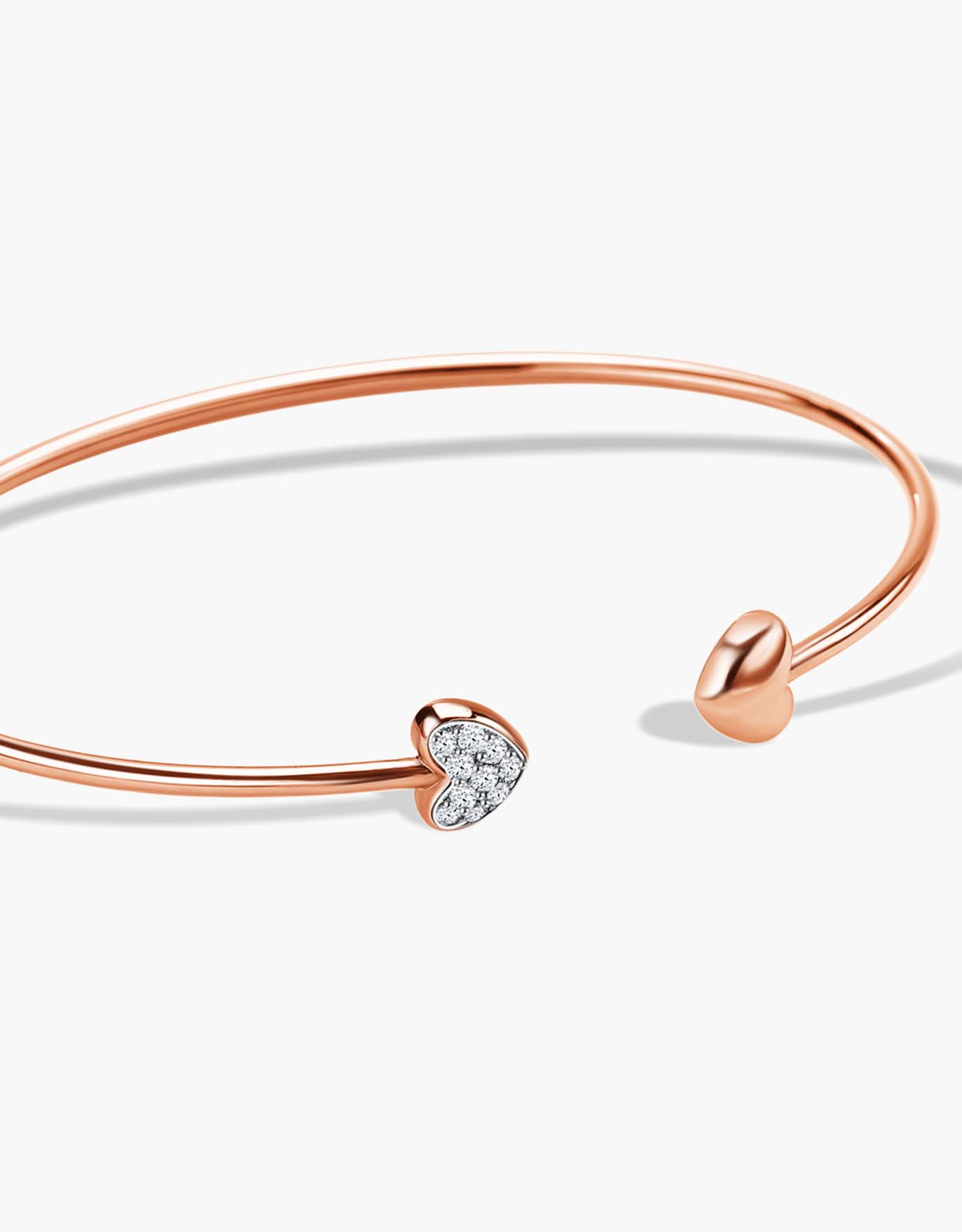 LVC  Diamond Bangle designed with two hearts aligned to each other with one encrusted in diamonds in rose gold