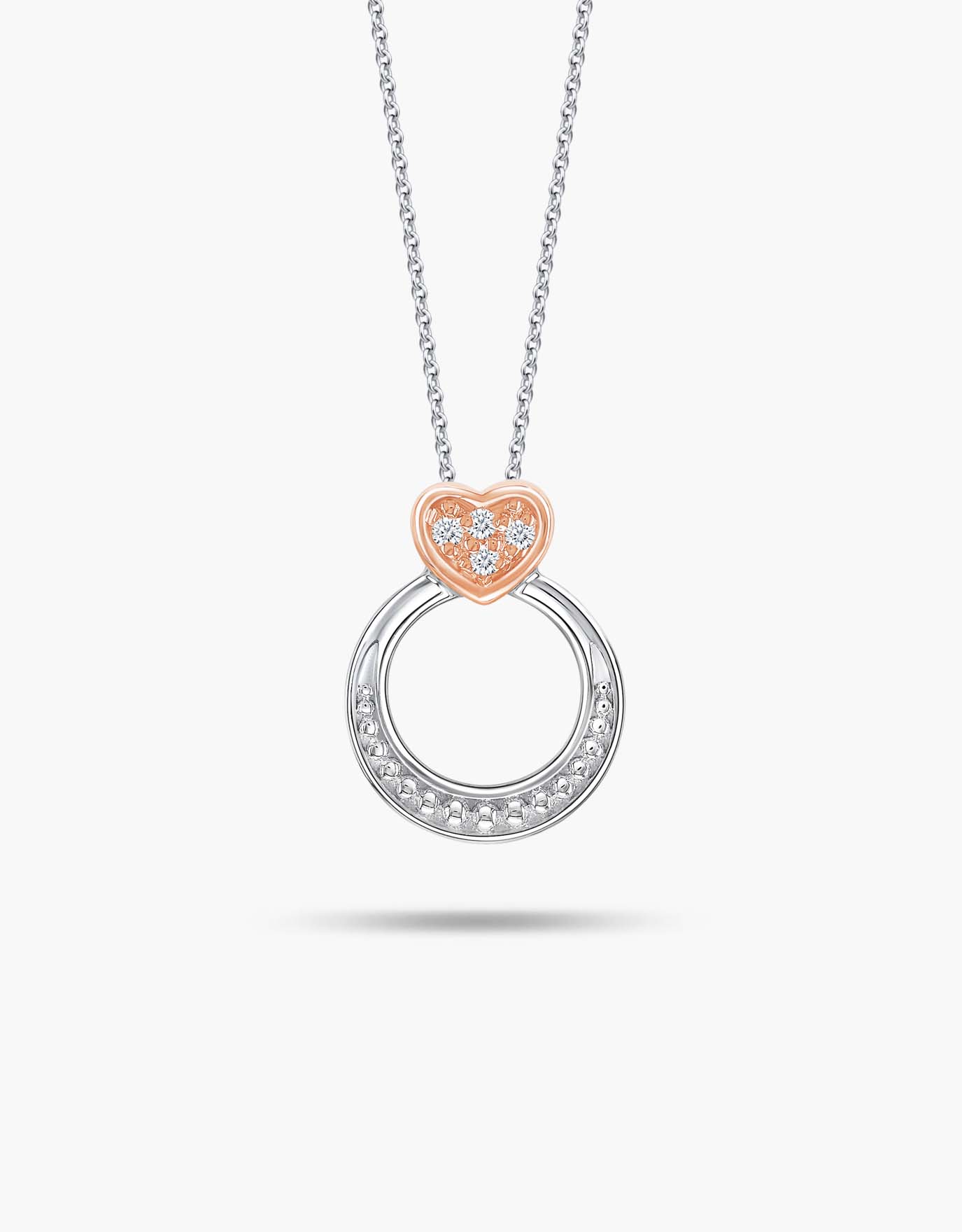 LVC necklace in white gold features a two-toned ring design with a rose gold heart