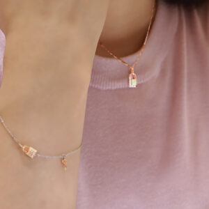 LVC BRACELETS CHERI PETIT LOCK DIAMOND GIFT SET model wearing the pendant in necklace in 14k and 18k white and rose gold